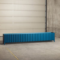 Modern blue storage bench with vertical striped pattern, featuring a sleek black frame, set against a neutral gray background.