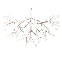 Elegant bronze chandelier with white floral patterns, featuring a unique branch-like design. Perfect for modern decor.