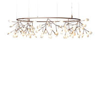 Metallic bronze chandelier with delicate white glass droplets mimicking floral branches in a modern design.