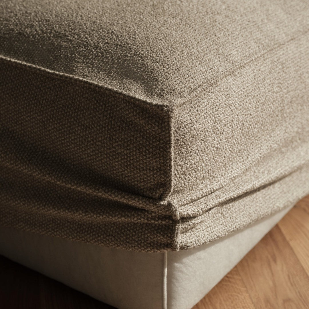 Beige textured fabric cushion with a smooth cream bottom, showcasing a natural and cozy aesthetic.