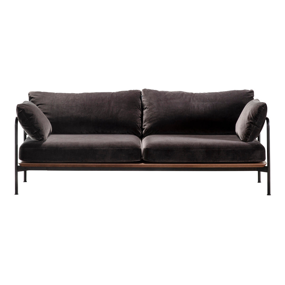 Stylish dark gray velvet sofa with sleek black metal frame and plush accent pillows, perfect for modern decor.