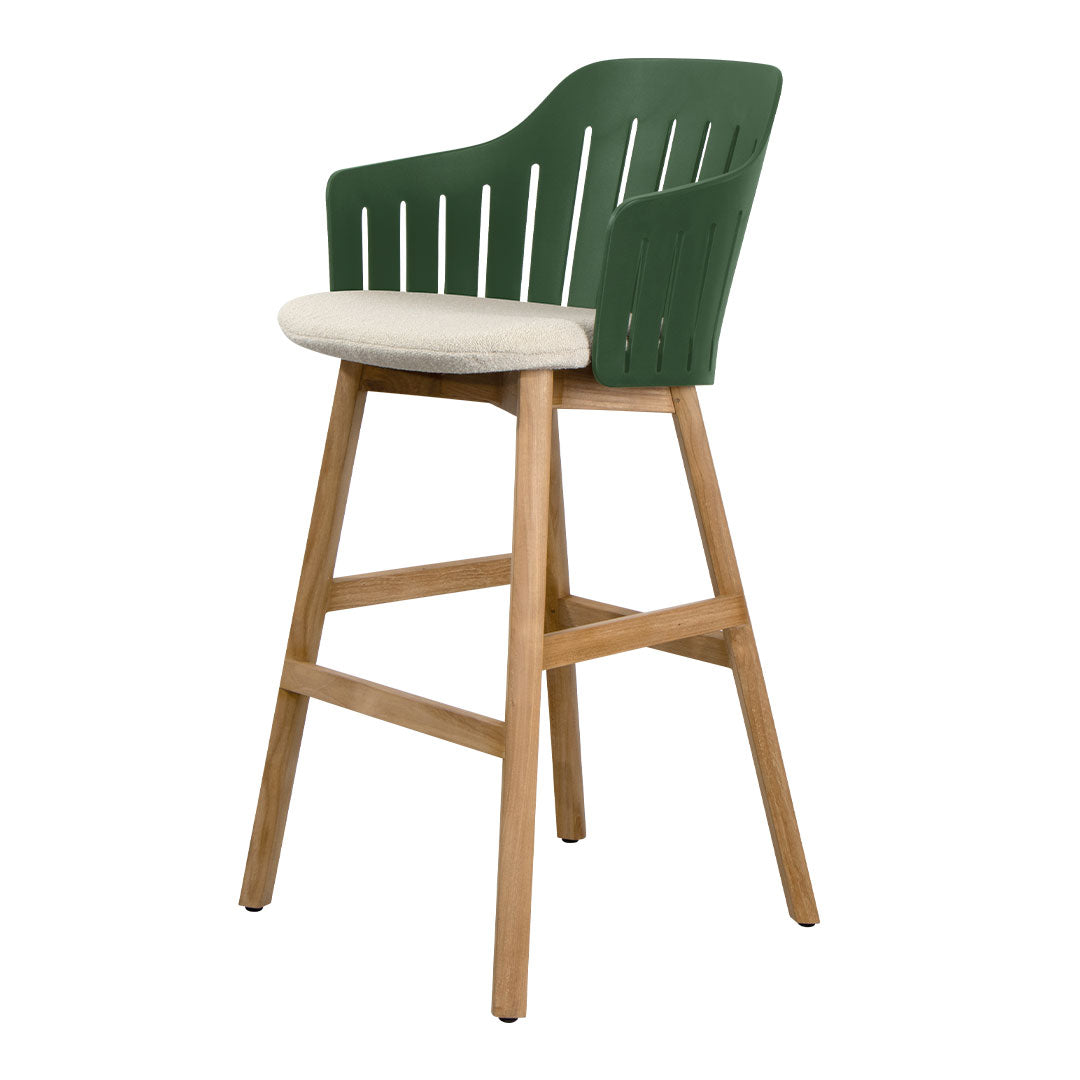 Green patterned backrest bar stool with a cream cushion and natural wood legs. Perfect for modern dining spaces.