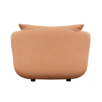 Soft peach couch with smooth fabric and minimalistic design, featuring subtle curves and a neutral tone.