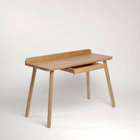 Light wood desk featuring a minimalist design with natural finish and a smooth surface, perfect for any workspace.