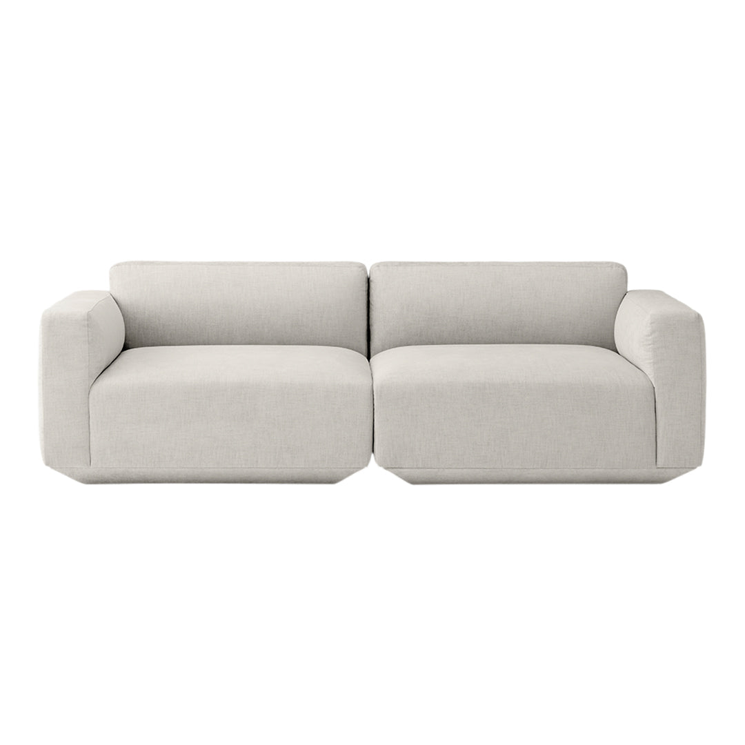 Light gray modern sofa with a minimalist design, featuring smooth, solid fabric and clean lines.