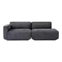 Gray upholstered sectional sofa with a modern, minimalist design and soft, textured finish.