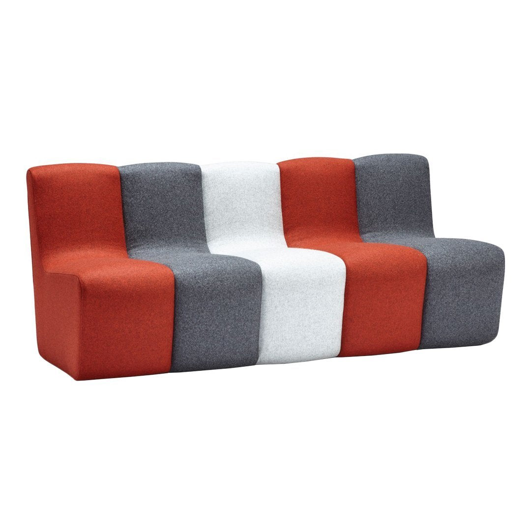 Three-seat sofa featuring vibrant red, gray, and white fabric blocks with a modern geometric pattern.