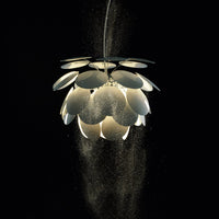 Modern pendant light with layered white petal design against a black background, creating a sleek, elegant look.