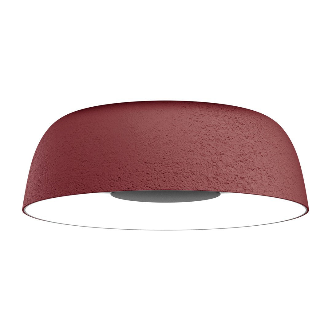 Red textured ceiling lamp with a smooth white underside, featuring a modern, minimalist design.