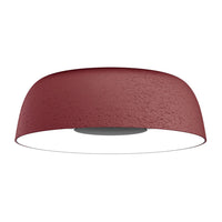Red textured ceiling lamp with a smooth white underside, featuring a modern, minimalist design.