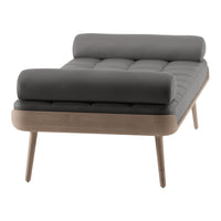 Gray tufted lounge chair with wooden legs and a modern design, featuring a sleek, minimalist aesthetic.