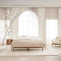 "Neutral-toned bedding set with subtle textured patterns, complemented by soft white and beige accents in a serene bedroom."