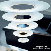 Modern hanging lamp with concentric white and black circular disks, creating a sleek and minimalist aesthetic.