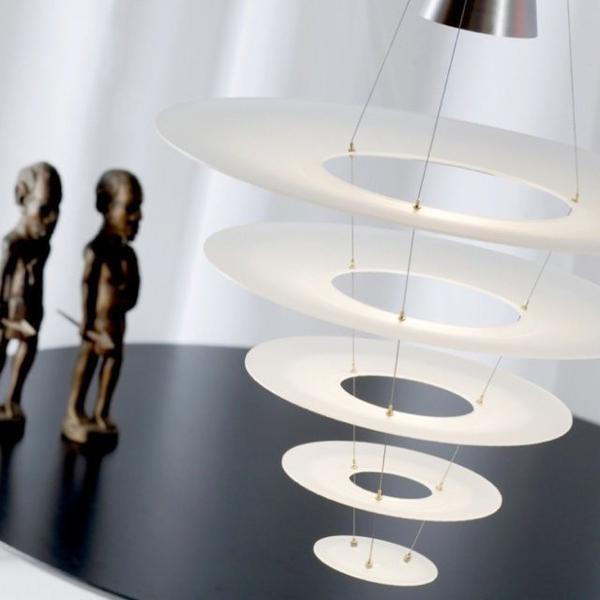 Elegant white circular pendant light with layered designs, featuring sleek metallic accents and dramatic geometric patterns.