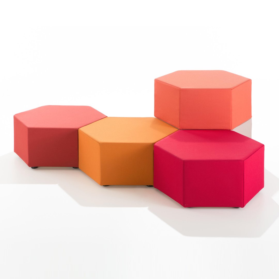 Hexagonal ottoman set in vibrant shades of pink, orange, and coral with a smooth, modern finish.