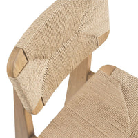 Natural beige woven chair with a textured pattern and wooden accents, showcasing a minimalist design.
