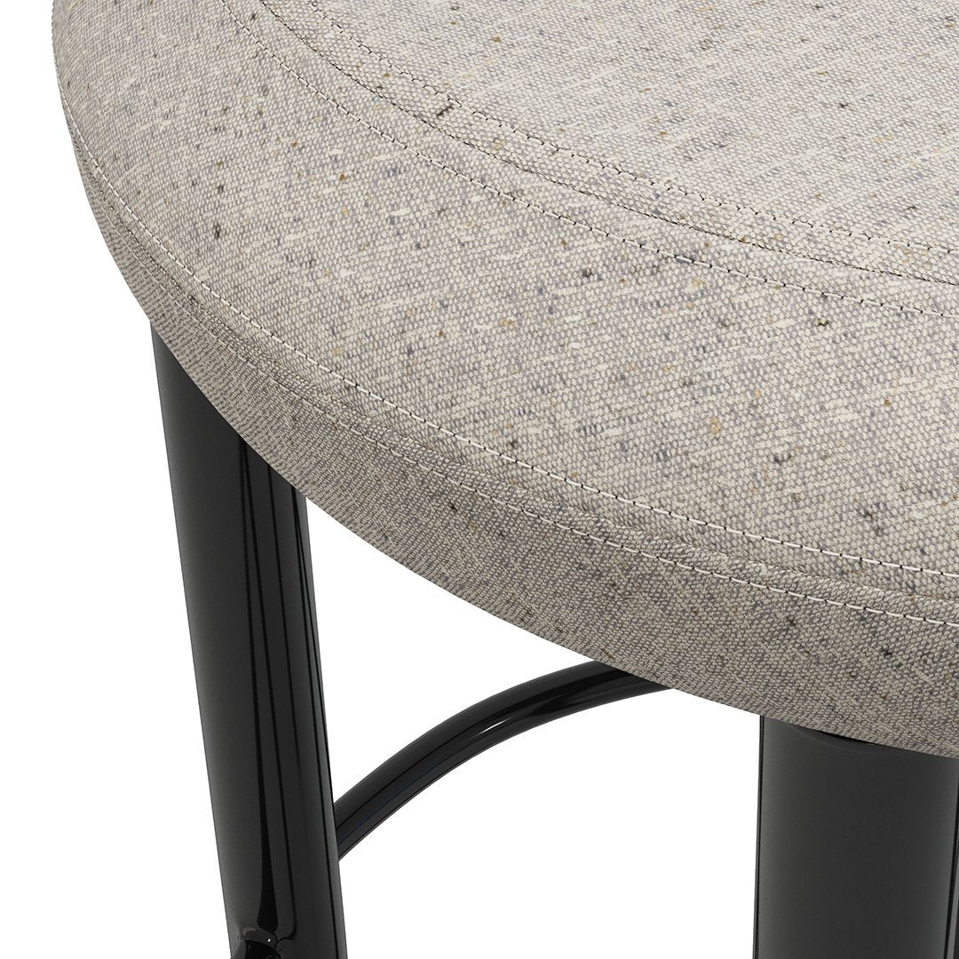 Gray speckled upholstery with black legs on a round stool, featuring a smooth, modern design.