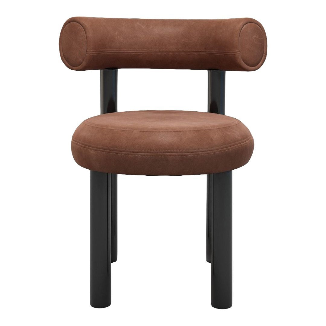 Round brown suede chair with black wooden legs, featuring a minimalist design and soft curves.