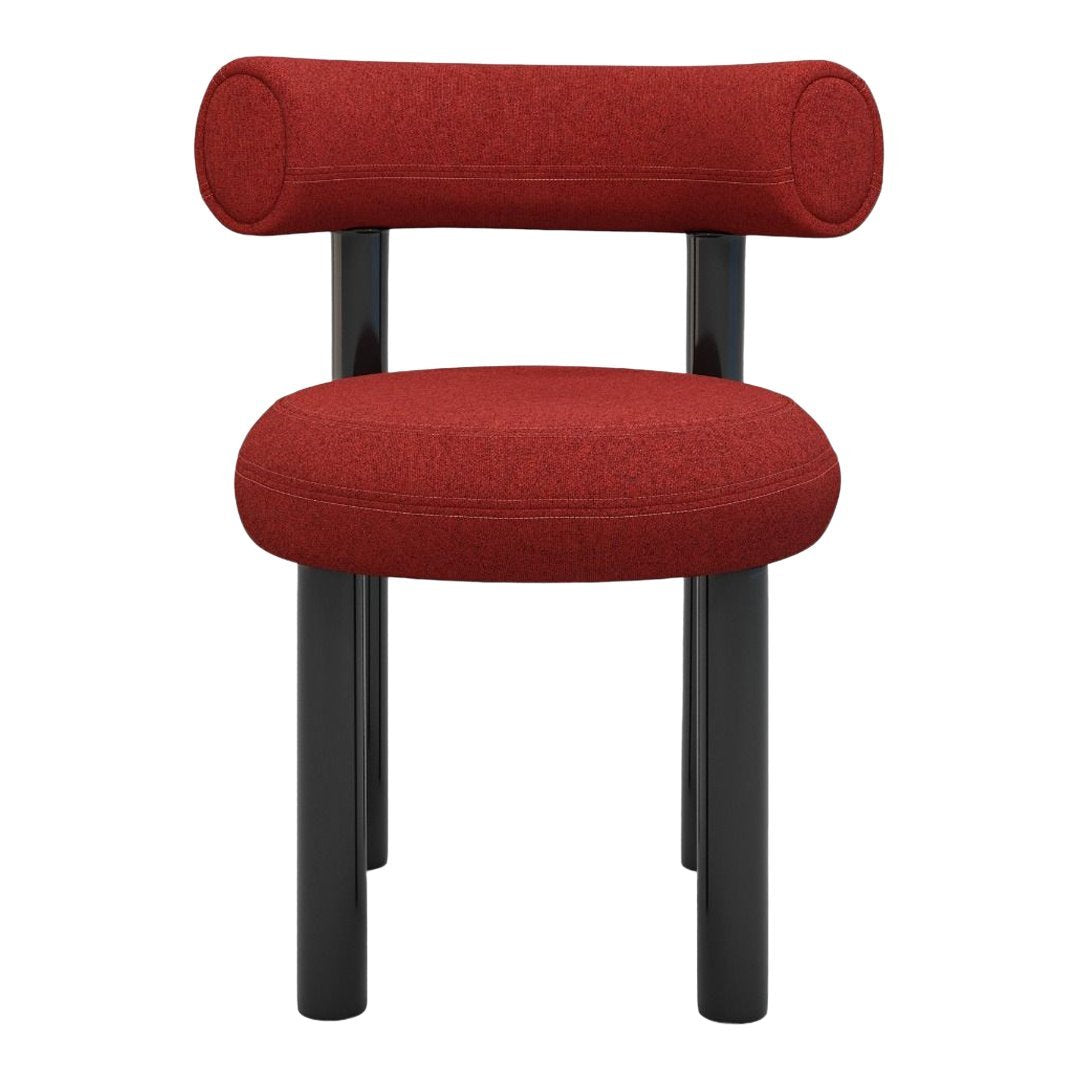 Red upholstered chair with cylindrical backrest and black legs, featuring a textured fabric. Ideal for modern interiors.