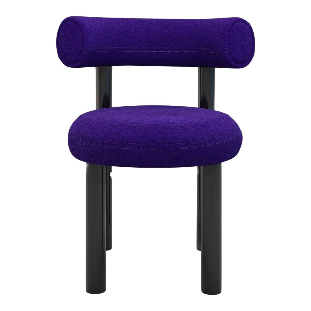 Vibrant purple upholstered chair with a minimalist design and sleek black legs. Perfect for modern decor.