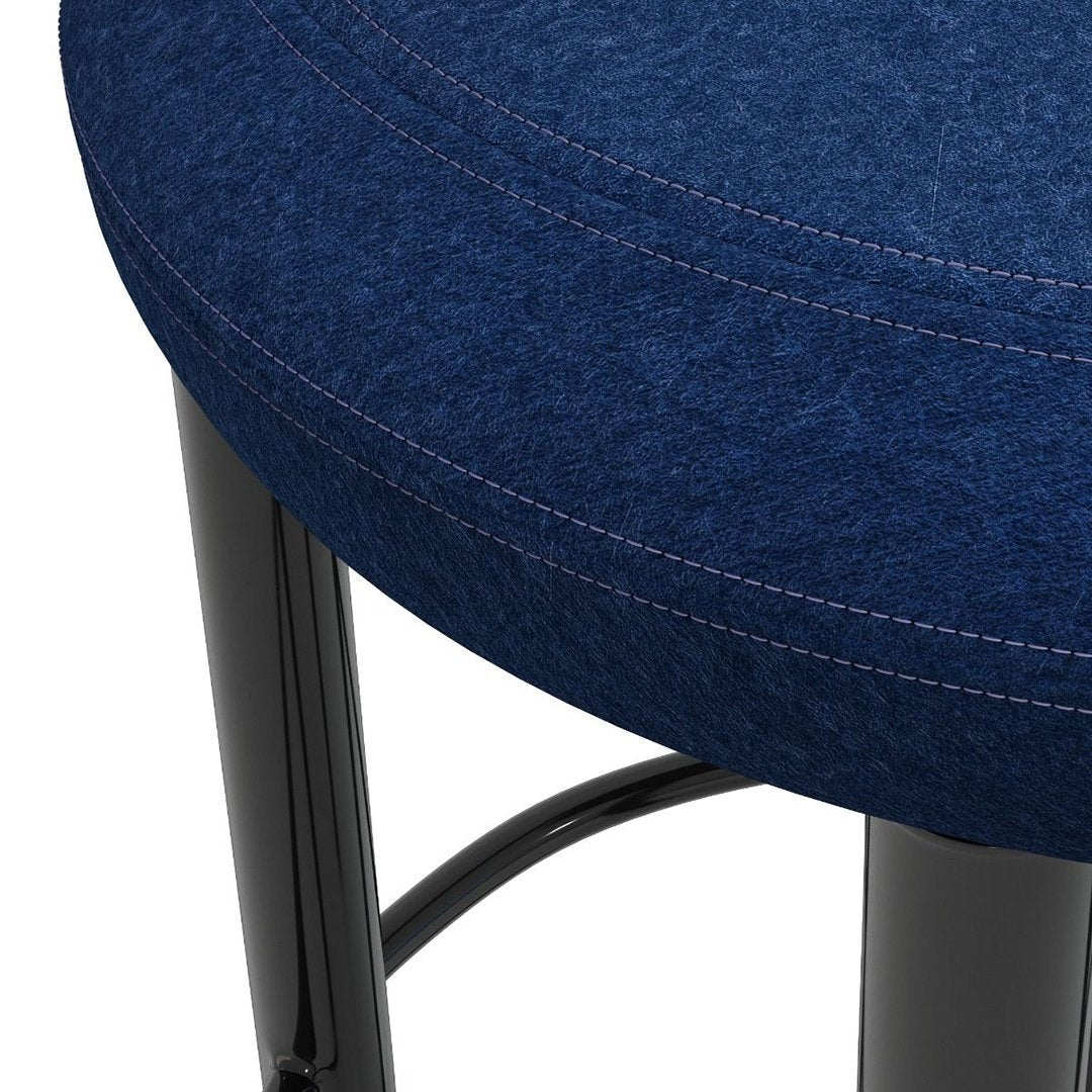 "Dark blue upholstered stool with light contrast stitching and sleek black metal base."