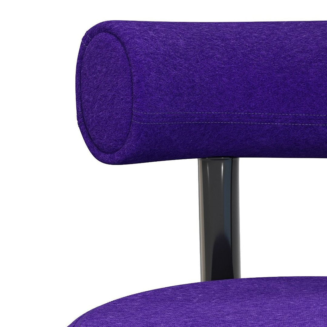 "Vibrant purple upholstery with a soft texture and sleek black metal frame."