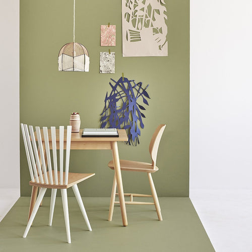 Light wood furniture with a soft green wall and abstract blue and pink patterns, creating a modern, serene atmosphere.