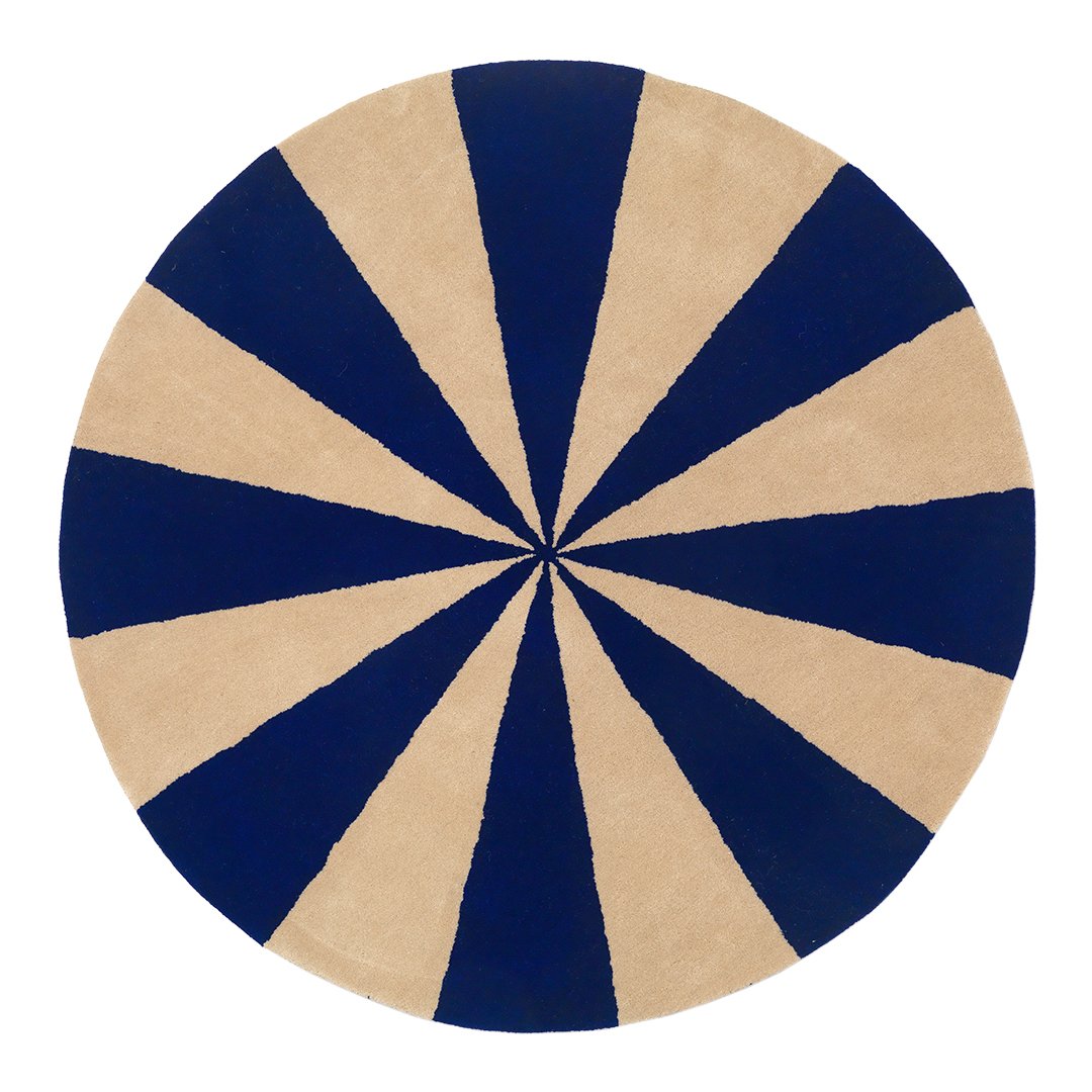 Round rug featuring alternating navy blue and beige stripes in a striking radial pattern. Perfect for modern decor.
