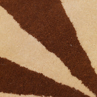 Tan area rug featuring bold brown diagonal stripes on a soft beige background. Perfect for adding warmth to any space.