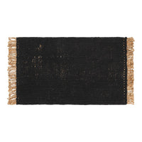 Black woven rug with beige fringes, featuring a textured pattern for a stylish, modern look.