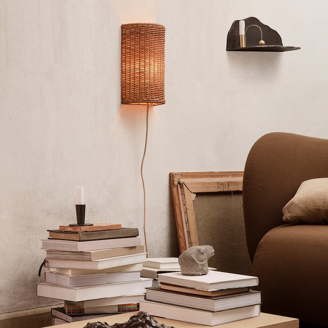 Woven rattan lamp in warm brown hues, complementing soft beige and earthy tones in a stylish living space.
