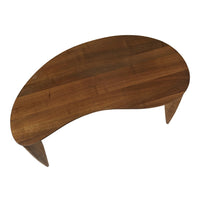 Curved wooden coffee table in rich brown tones with a smooth finish and minimalistic design.