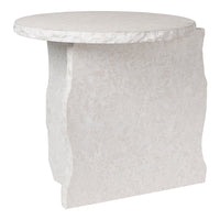 "Round white side table with a textured finish and unique, organic shape."