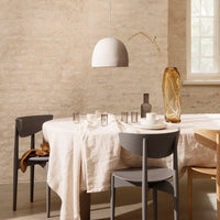 "Minimalist dining setup featuring beige, gray, and amber tones with soft textures and natural patterns."