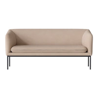 Beige modern sofa with rounded edges and sleek black metal legs, showcasing a minimalist design.