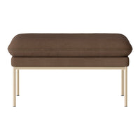 Brown upholstered ottoman with a smooth texture and sleek beige metal legs. Modern and minimalist design.