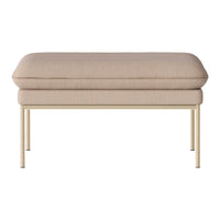 Beige upholstered ottoman with a smooth, textured surface and sleek gold metal legs. Perfect for modern decor.