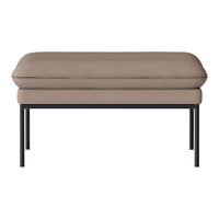 Beige cushioned bench with a sleek black metal frame, featuring a smooth, minimalist design. Perfect for modern decor.