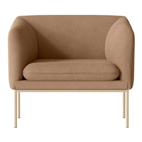 Tan upholstered accent chair with smooth, rounded lines and a minimalist cream metal frame. Perfect for modern decor.