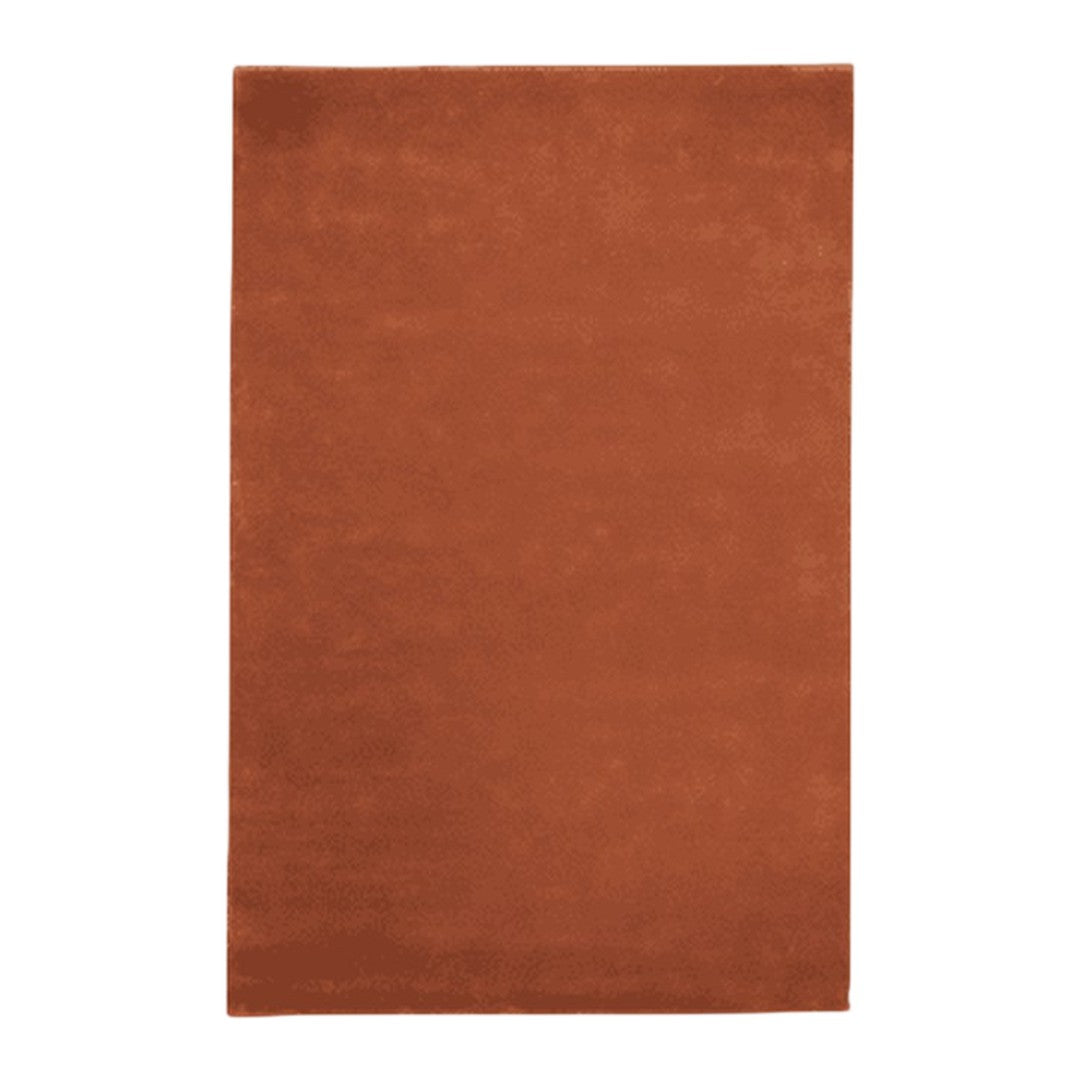 Rust-colored solid area rug with a smooth, soft texture, perfect for adding warmth to any space.