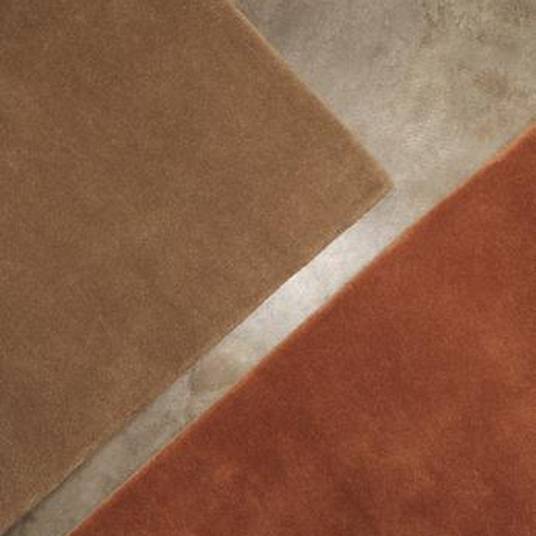 Brown and rust-colored rectangular rugs with a soft texture on a smooth, muted gray background.