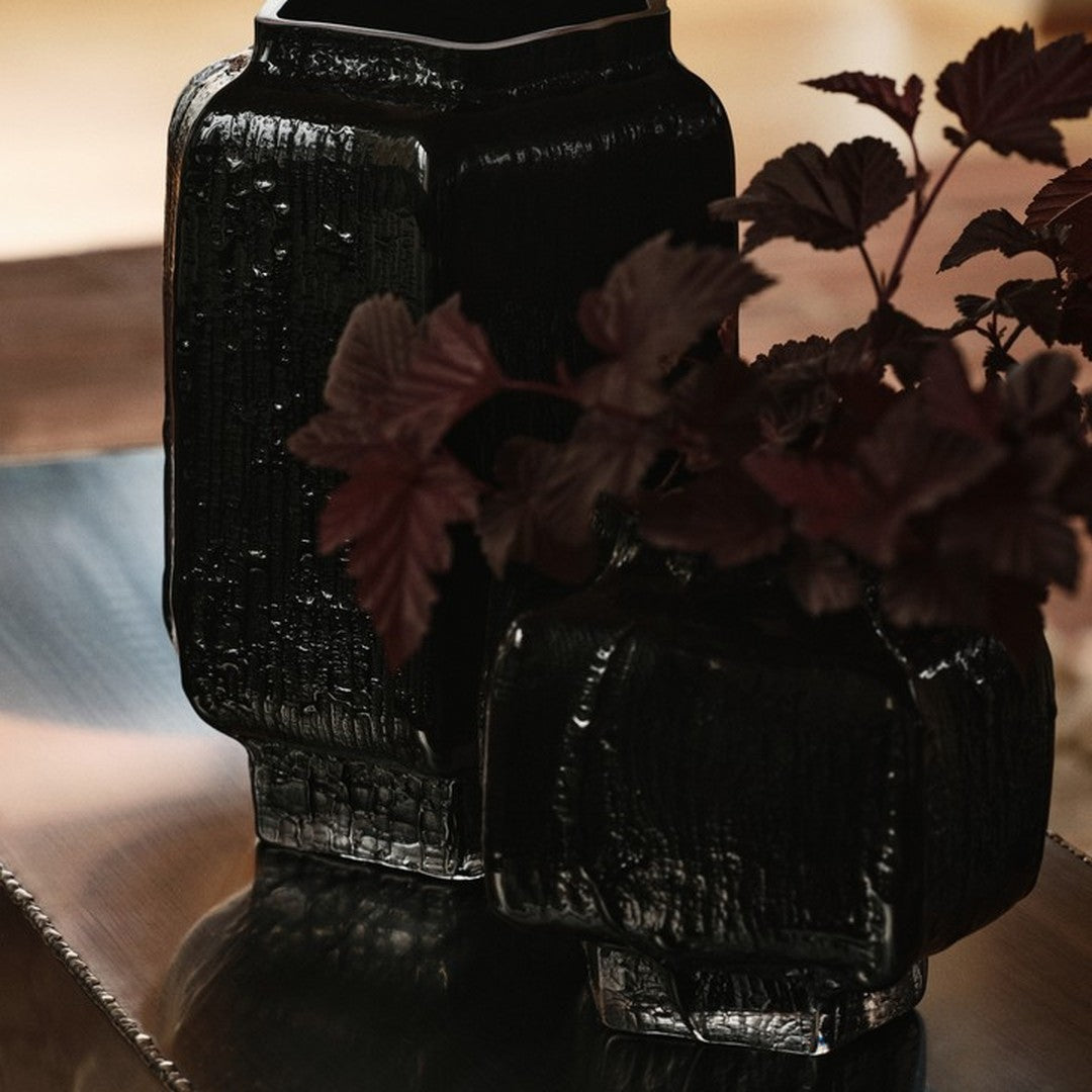 Black textured vases with deep burgundy foliage, showcasing a modern and elegant design. Perfect for home decor.
