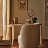Light wood desk with a smooth surface, paired with a soft beige chair, featuring natural earthy tones and minimal patterns.