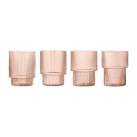 Set of four glass vases in soft rose color with vertical ribbed texture. Elegant and modern design.