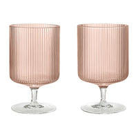 Set of two ribbed glass goblets in soft pink with transparent bases, perfect for stylish dining.