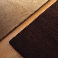 Textured brown and beige rugs showcasing rich earthy colors for a cozy home aesthetic.