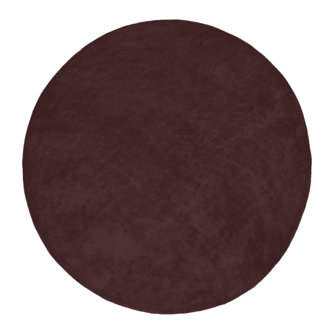 Round burgundy rug with a soft, plush texture, showcasing a solid color. Perfect for adding warmth to any space.