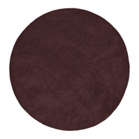 Round burgundy rug with a soft, plush texture, showcasing a solid color. Perfect for adding warmth to any space.