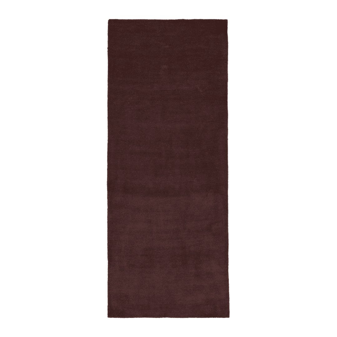 Deep burgundy solid area rug with a soft, textured finish, perfect for adding warmth to any space.
