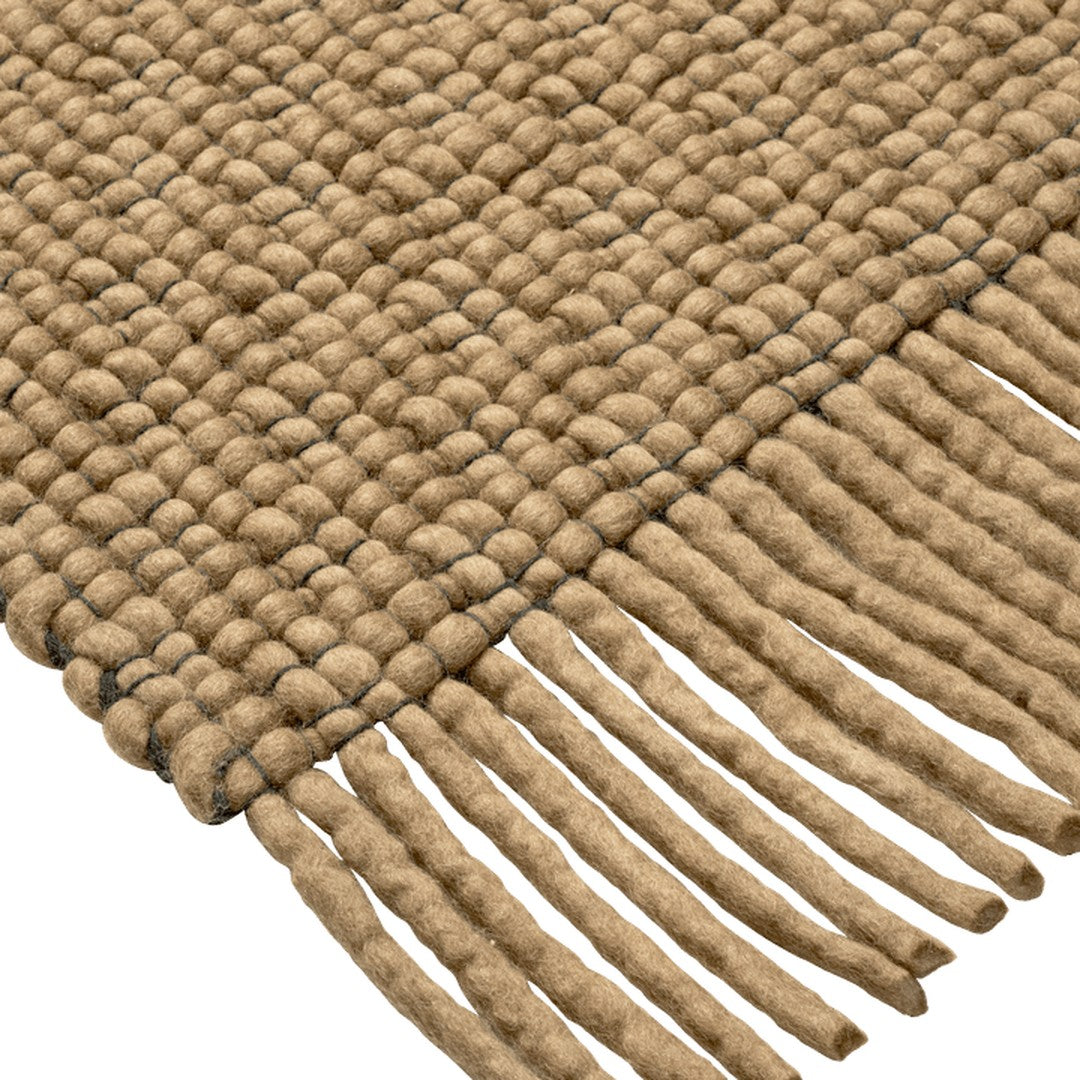 Braided jute rug in natural brown with textured pattern and fringed edges, perfect for rustic decor.